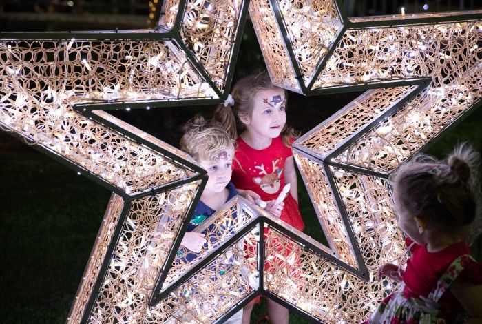two children looking through a star shaped light