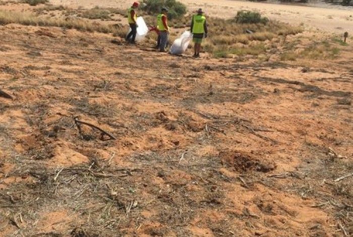 Environment conservation team clearing litter from natural environment