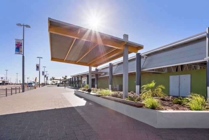 image of entrance of karratha airport with sun peering through roof