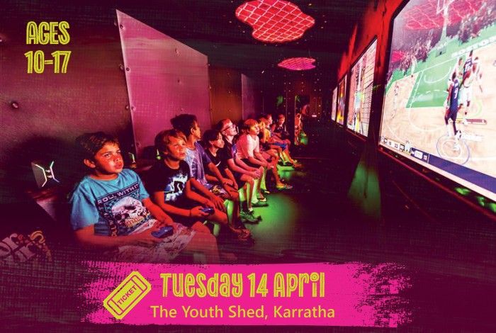 A group of young people sit in a gaming room playing video games on large screens, holding controllers and focused on the gameplay. A pink banner reads “Tuesday 14 April – The Youth Shed, Karratha,” and text on the left says “Ages 10–17.”