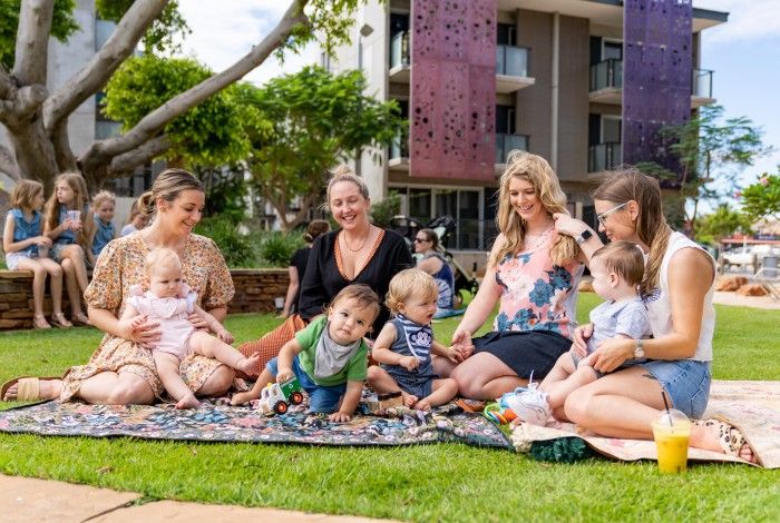 A family sitting on grass at the Quarter